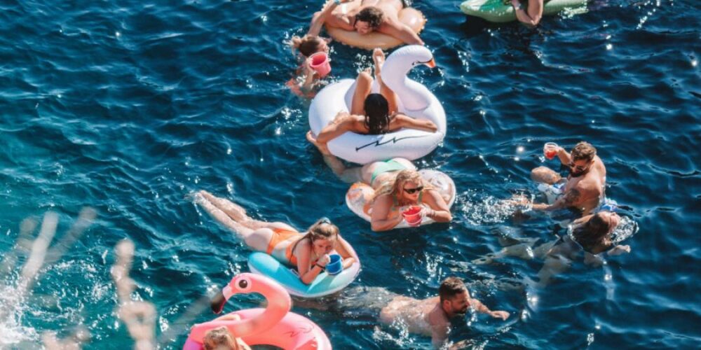 Grab your floaties and relax by Harmony Ios Greece floatopia event in ios greece. Famous beach part in Ios, mylopotas beach