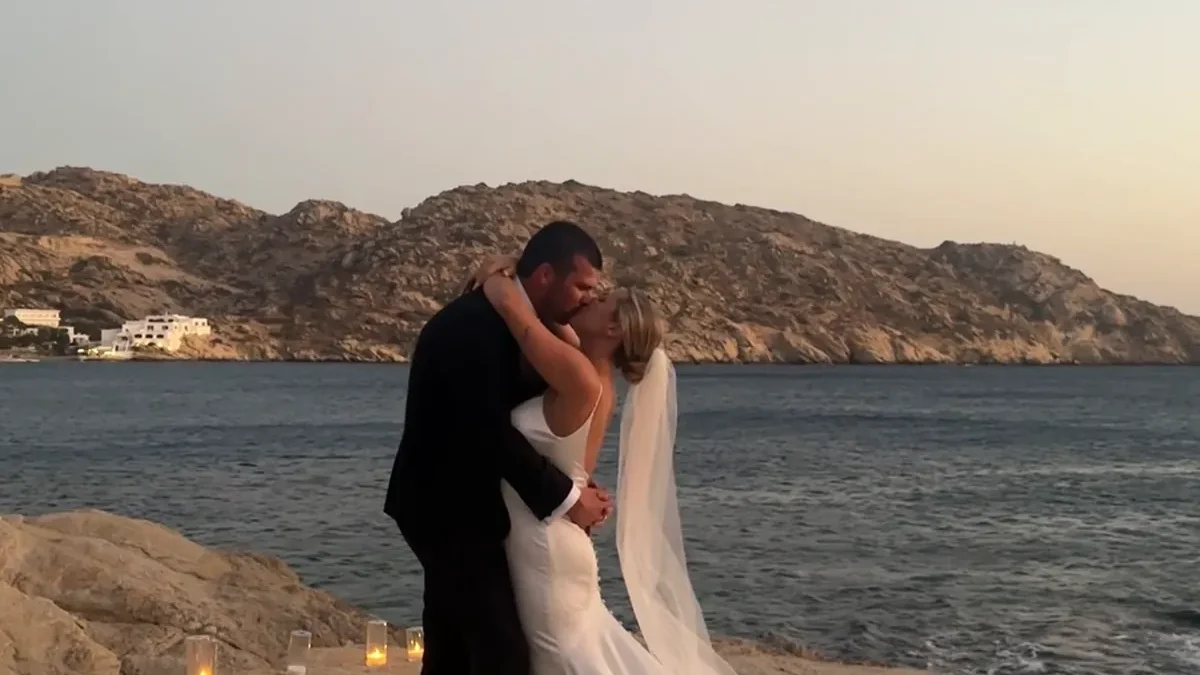 harmony-ios-wedding-in-ios-greece Mylopotas Beach in Ios, Greece, overlooking the turquoise Aegean Sea and surrounding Cycladic landscape`