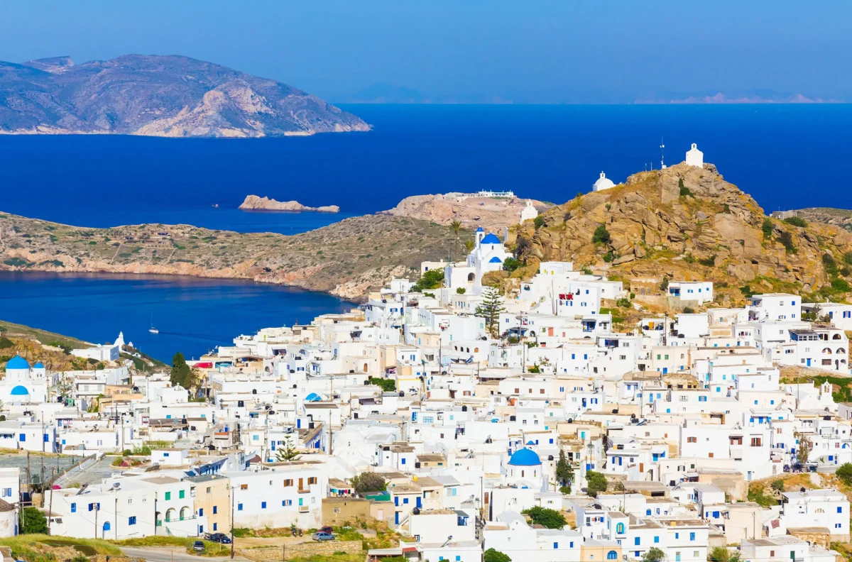 Panoramic view of Ios, Greece, showing the whitewashed buildings of Chora and the Aegean Sea, for a guide on where to stay in Ios in 2027.