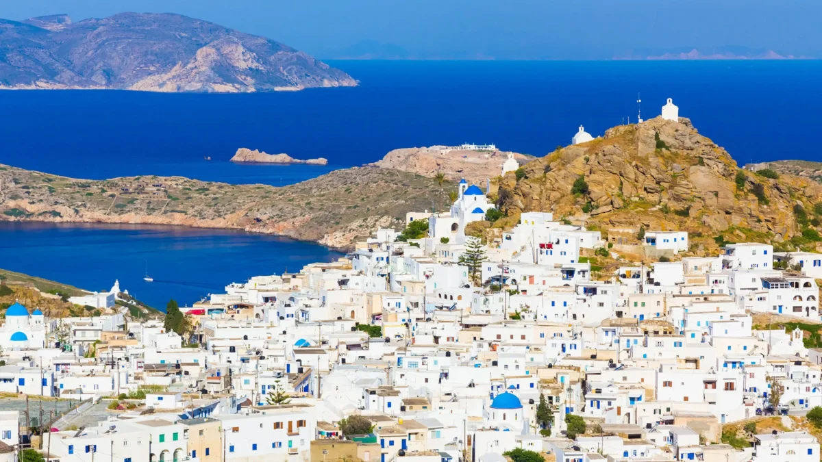 Panoramic view of Ios, Greece, showing the whitewashed buildings of Chora and the Aegean Sea, for a guide on where to stay in Ios in 2027.