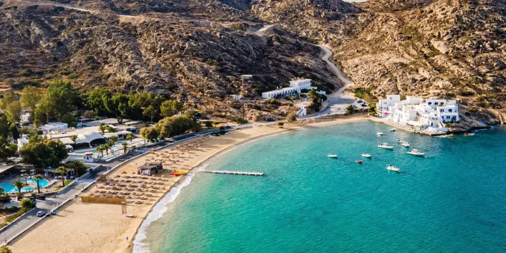 mylopotas-beach-ios-aerial-website-1200x800 Aerial view of Mylopotas Beach in Ios, Greece, with turquoise water, golden sand and surrounding mountains
